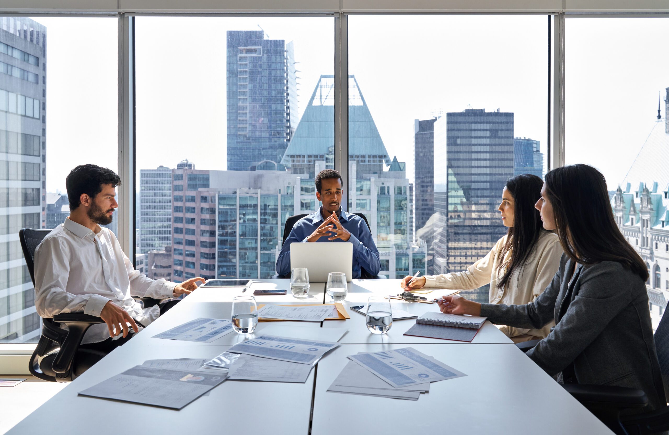 Busy international professional business team at group meeting in board room.